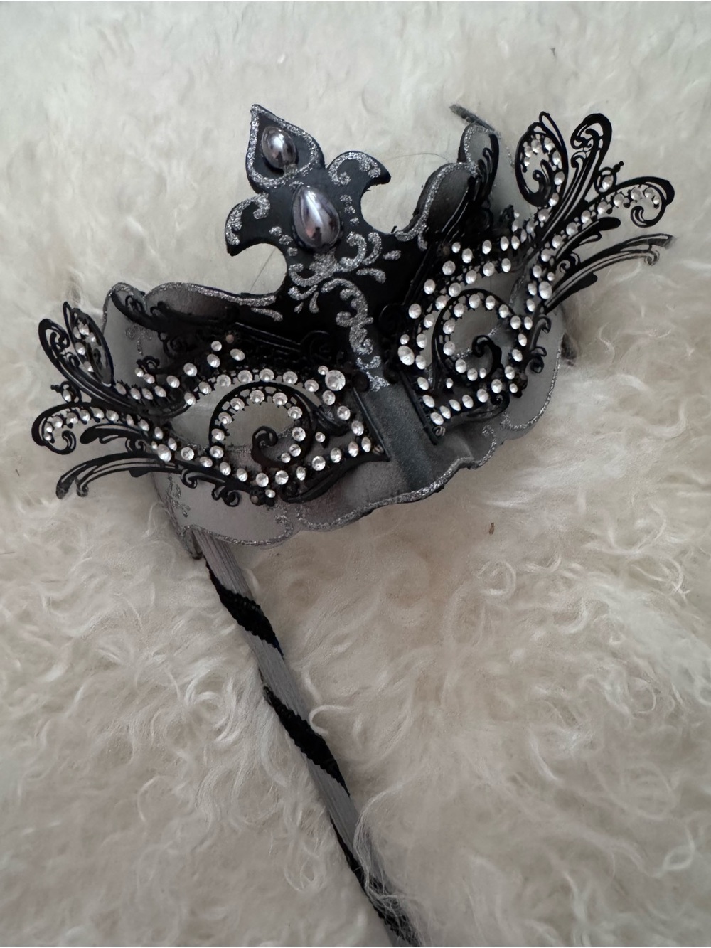 Elegant Venetian-handheld stick masquerade mask.